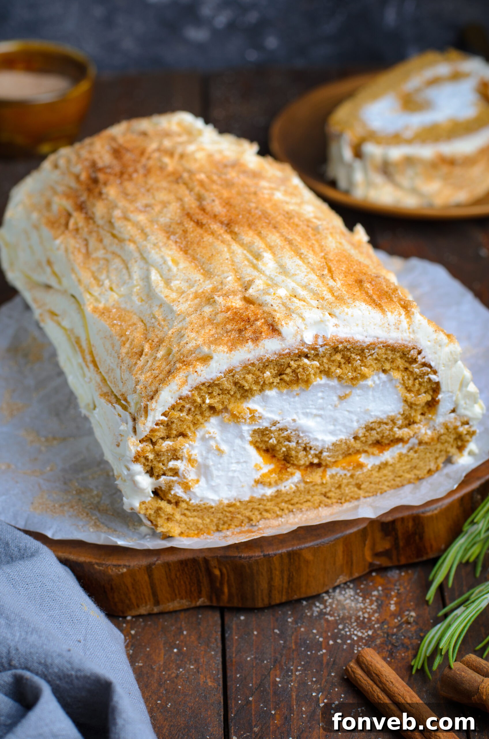 Close up view the Gingerbread Cake Roll on a brown serving platter