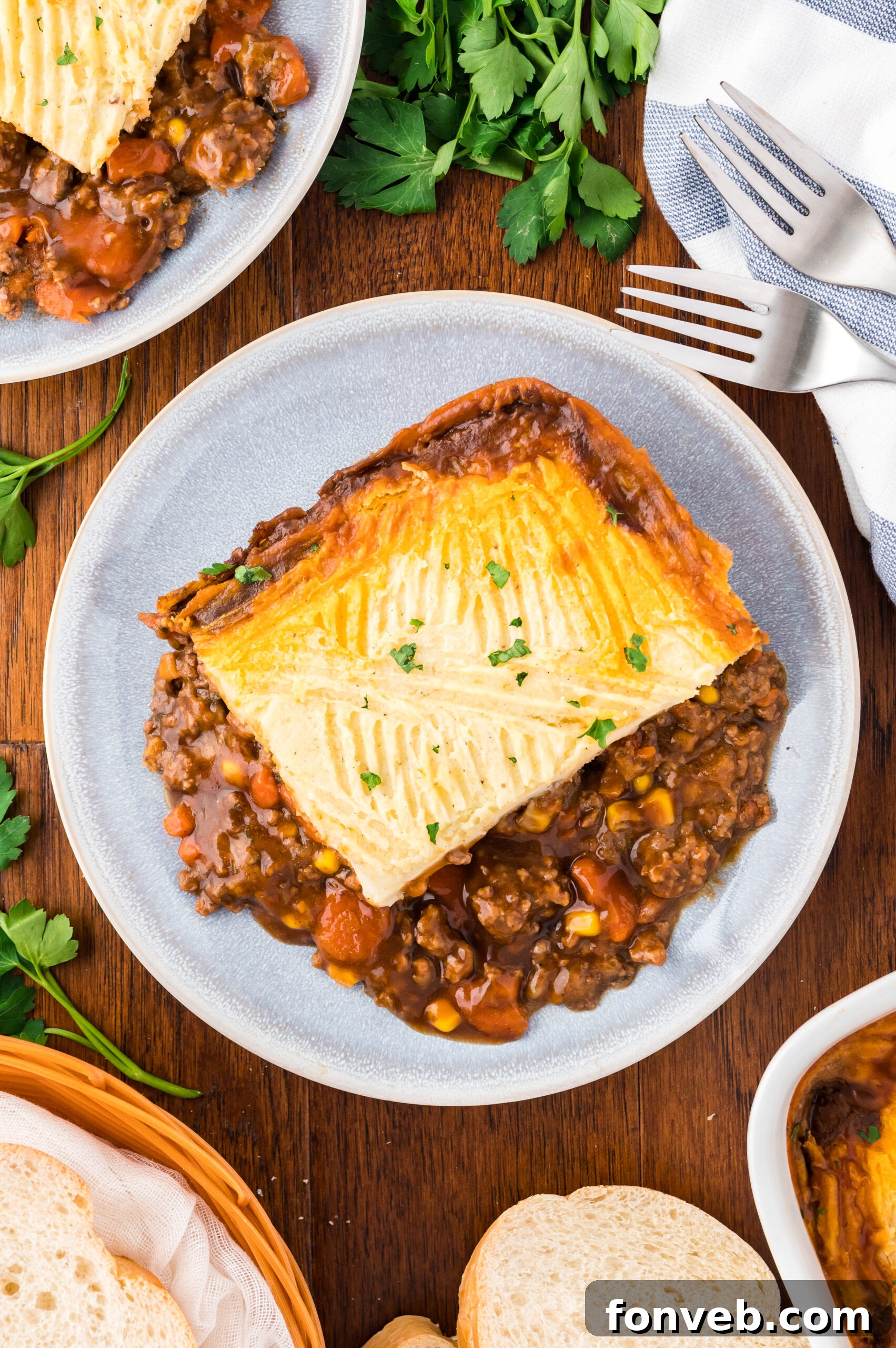 An overhead shot showcasing a freshly baked Shepherd's Pie on a gray and white plate, ready to be served.
