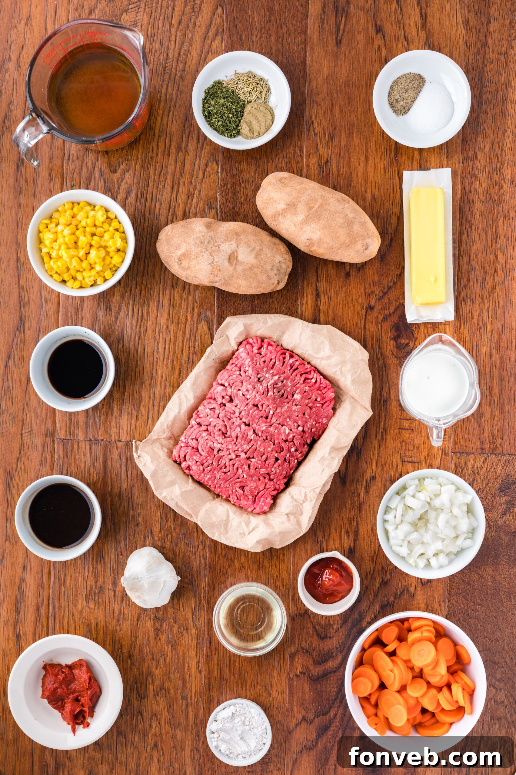 An overhead shot displaying all the fresh and canned ingredients meticulously laid out, ready for preparing the Shepherd's Pie recipe.