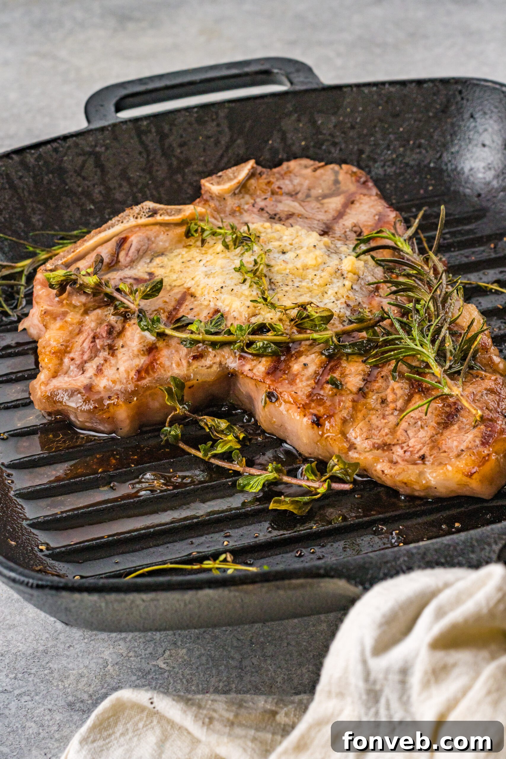 Front view of T Bone Steak in a cast iron skillet.
