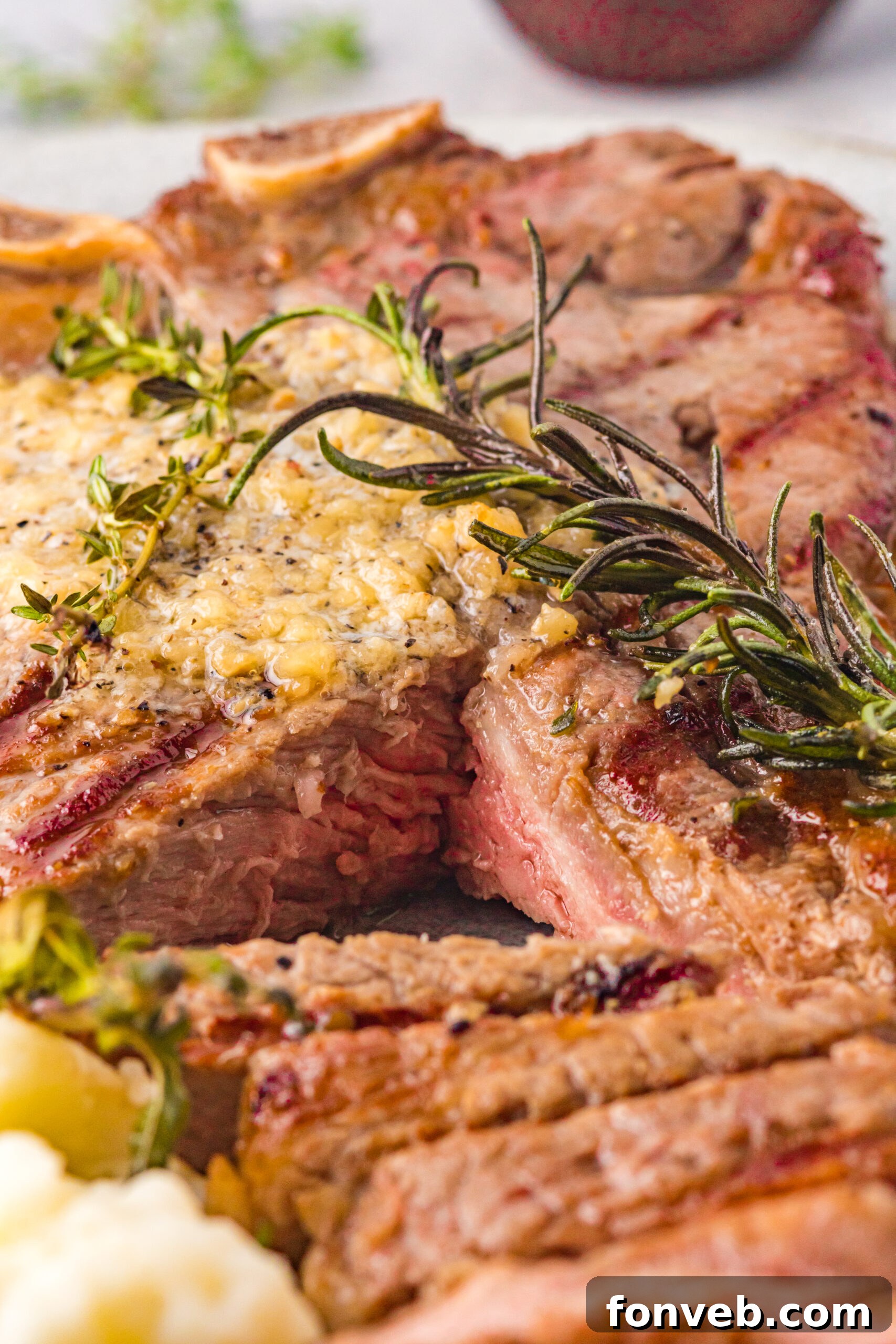 Close up view of T Bone Steak with a bite removed.
