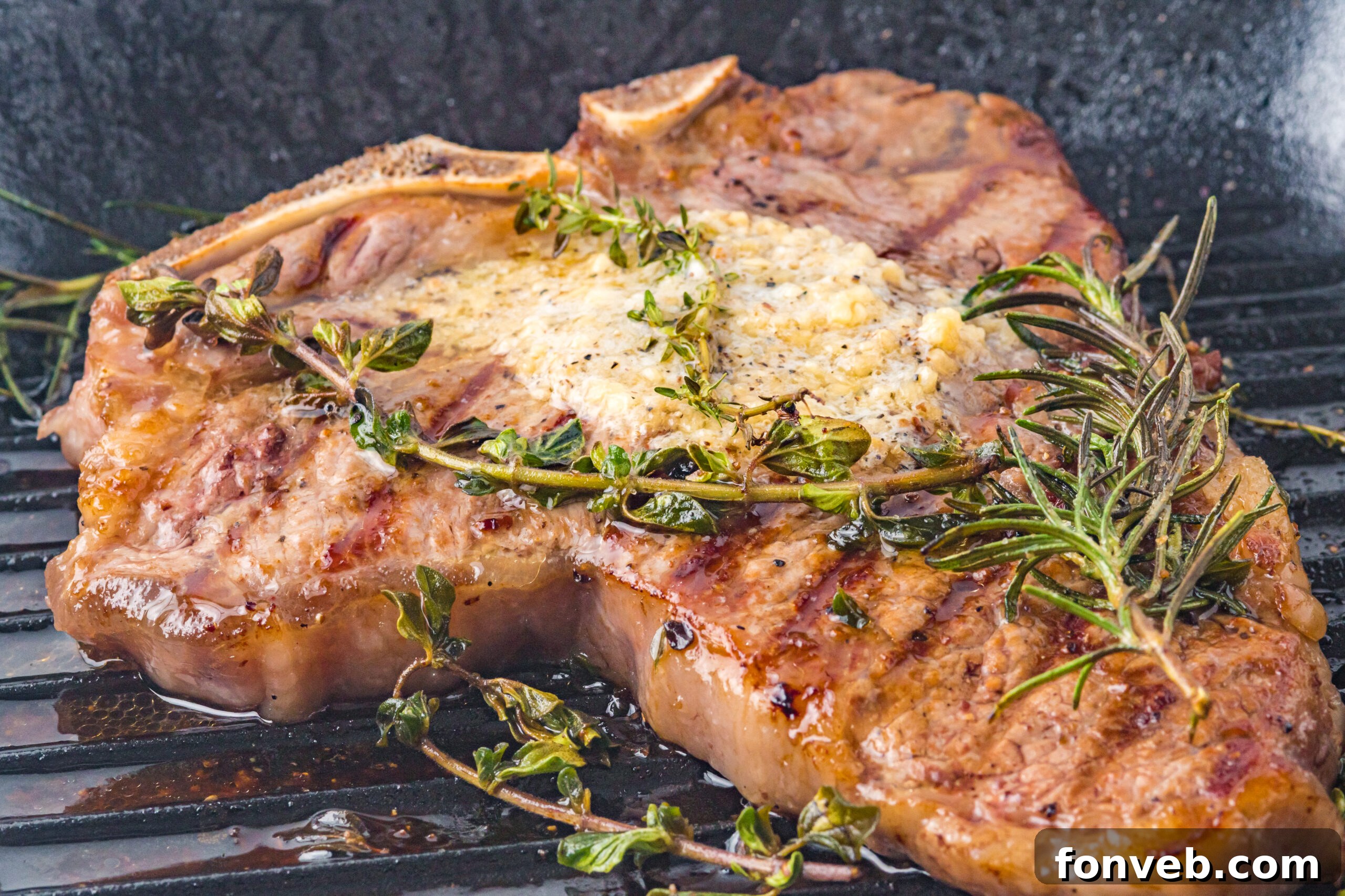 T bone steak in a grill frying pan topped with butter