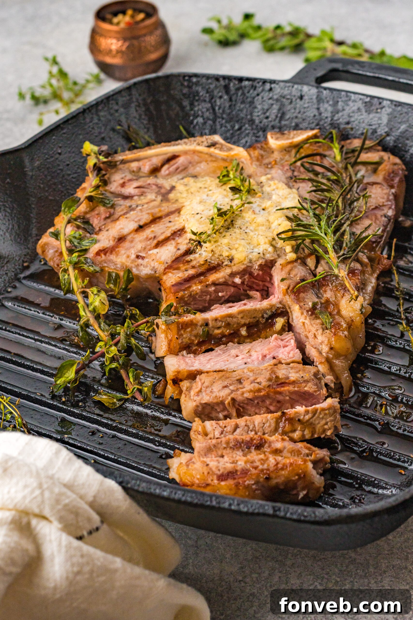 Front view of T Bone Steak in a cast iron skillet.