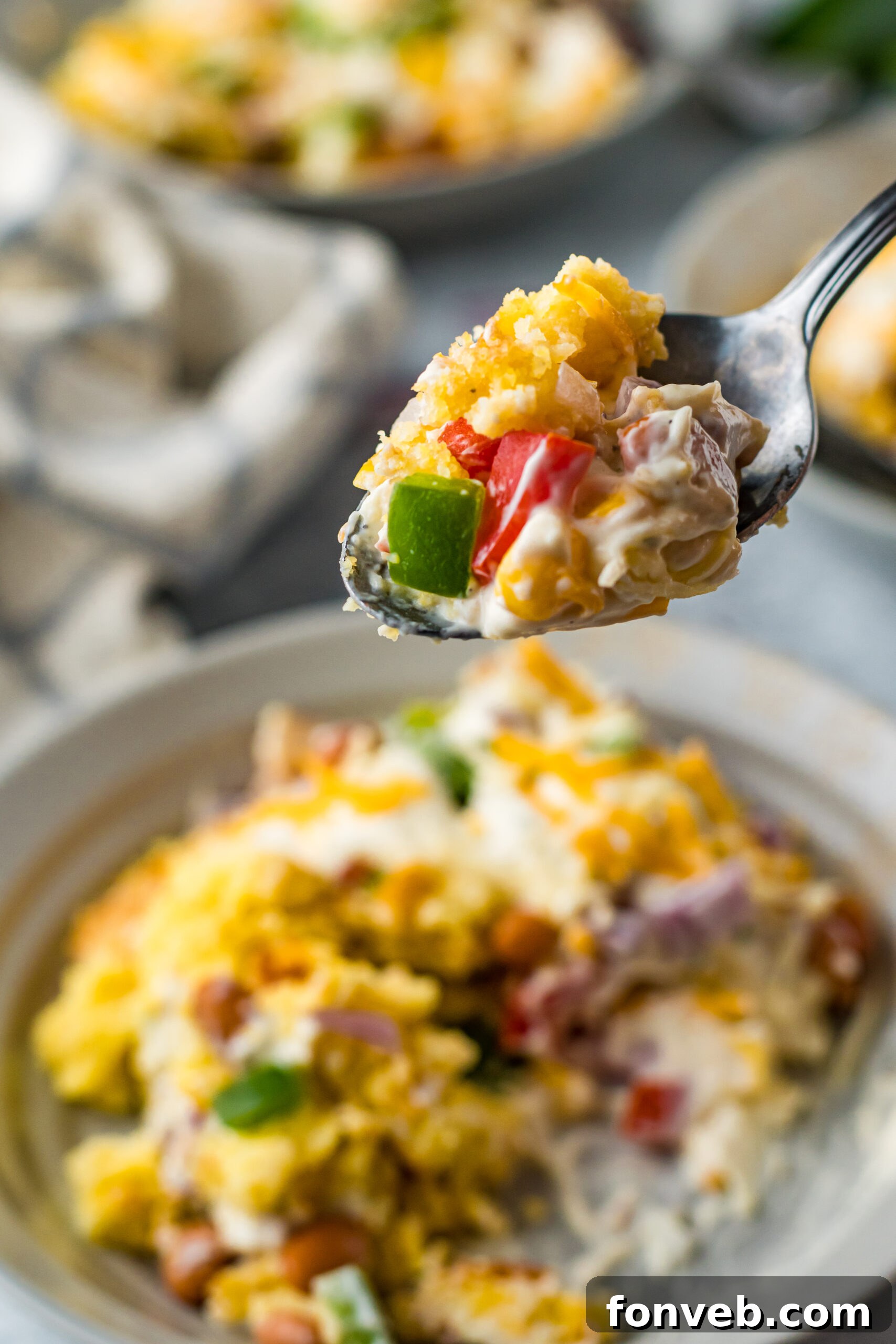 Southern Cornbread Delight 16 Front view of a bite of Cornbread Salad on a silver spoon.