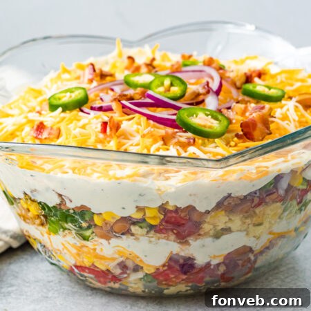 Southern Cornbread Delight 19 Cornbread Salad in a bowl with a silver spoon.