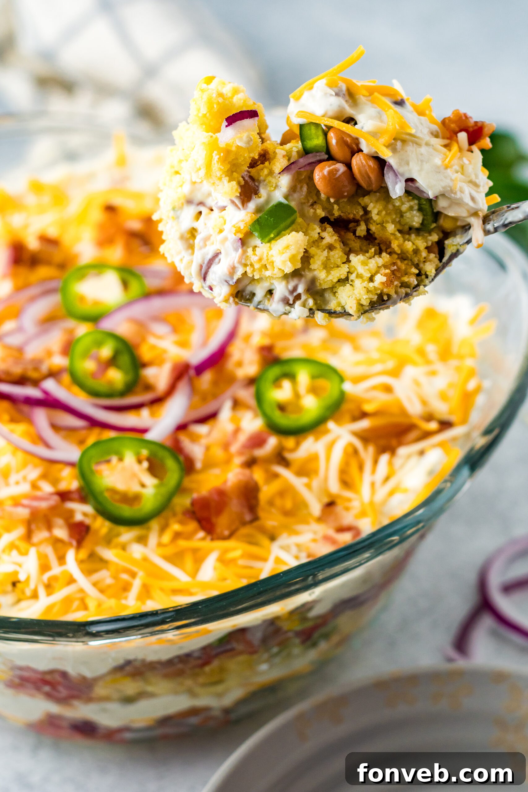 Southern Cornbread Delight 4 Front view of a serving of Cornbread Salad on a silver serving spoon.