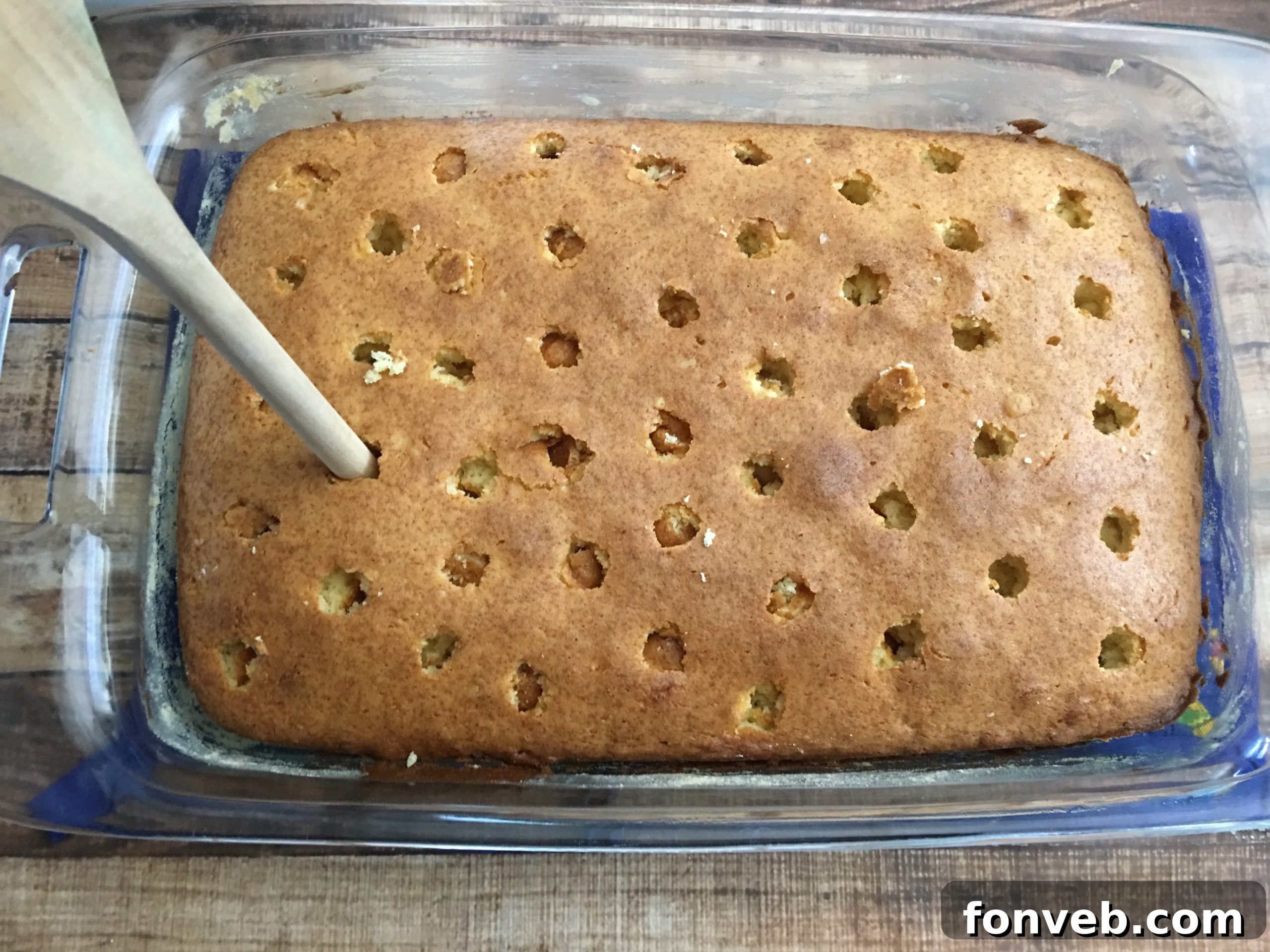 Close-up of a moist slice of Pina Colada Poke Cake