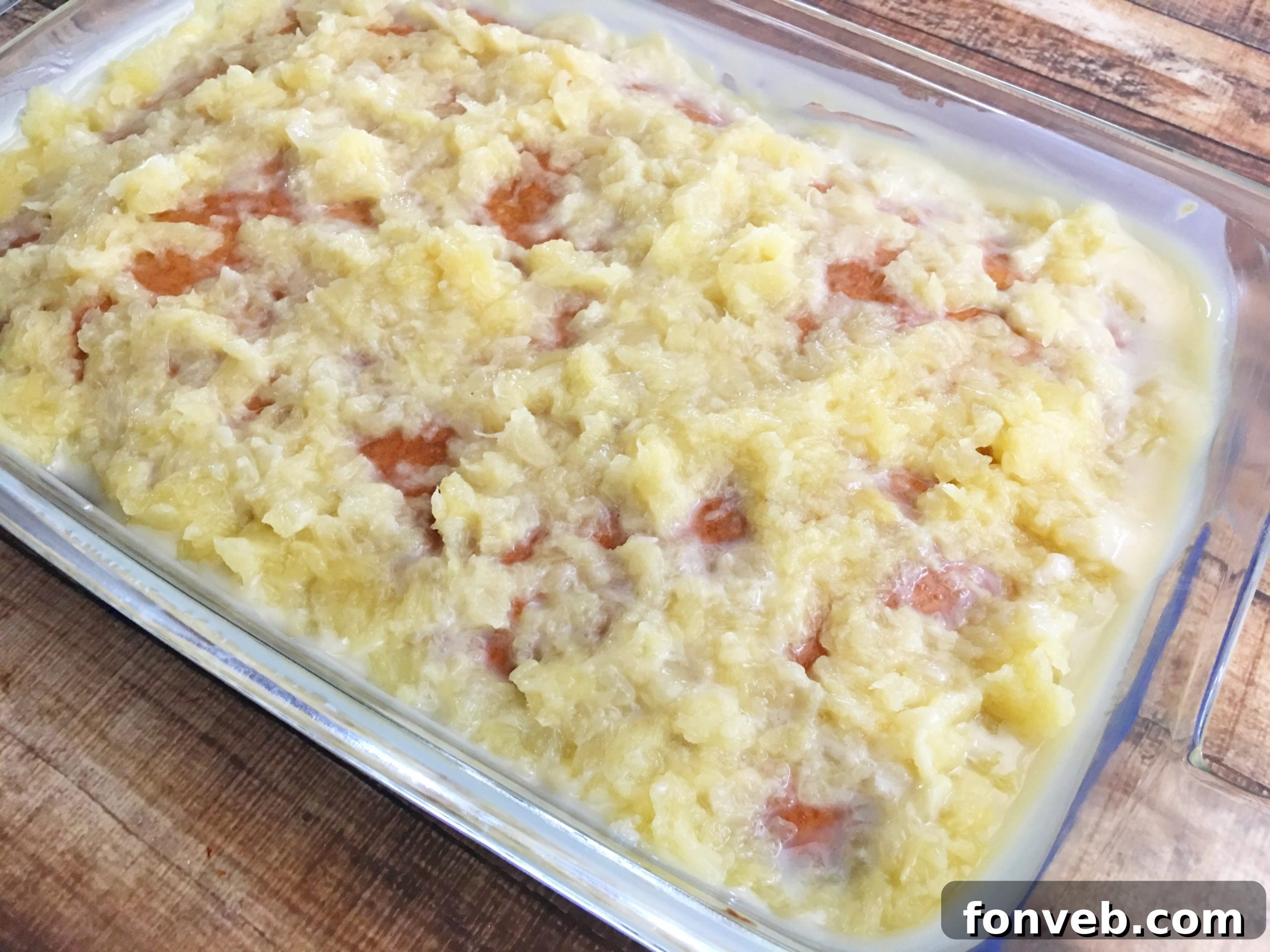 Cream of coconut added to the pineapple and condensed milk mixture