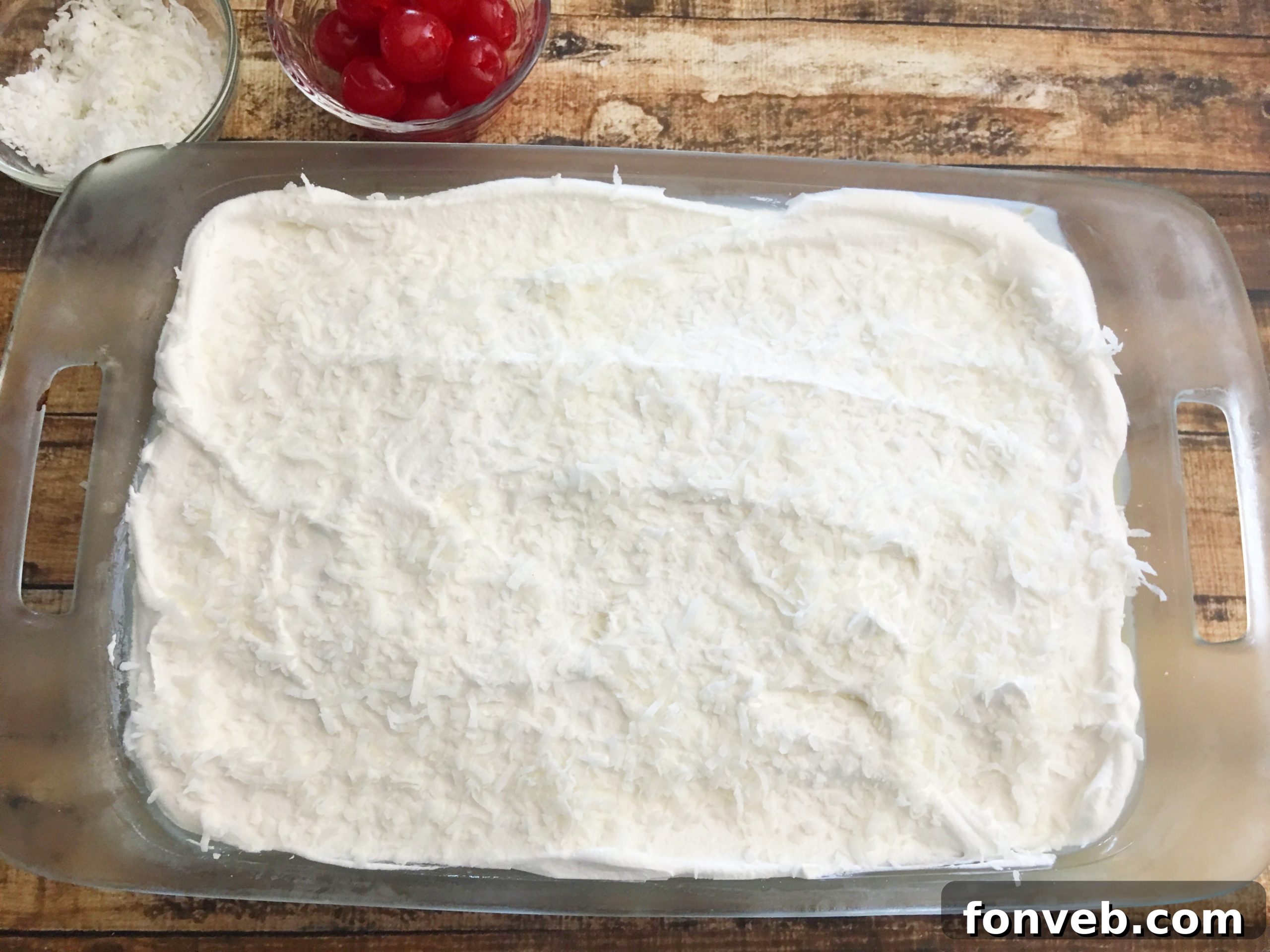 Vanilla extract being added to the whipped cream