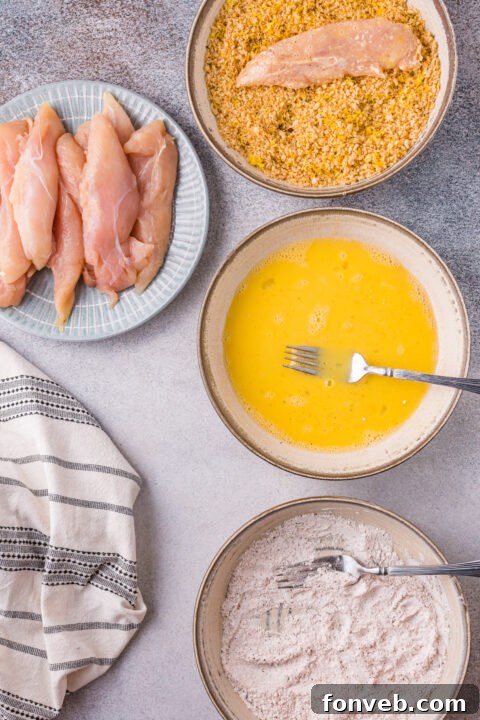 Baked golden-brown biscuits on a baking sheet.