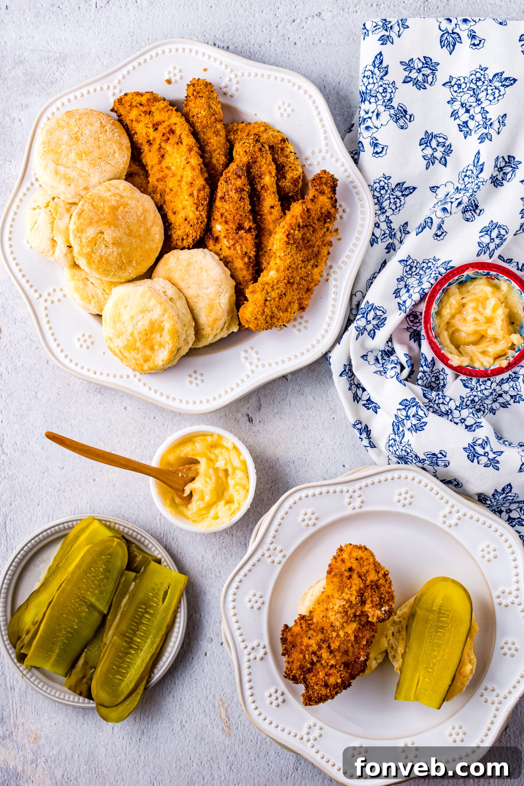 Overhead view of Honey Butter Chicken Biscuit unassembled on a white dish, displaying all components before assembly.