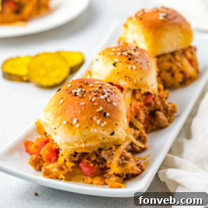 A perfectly styled image of Cheesy Chicken Sloppy Joe Sliders, enticing and delicious.