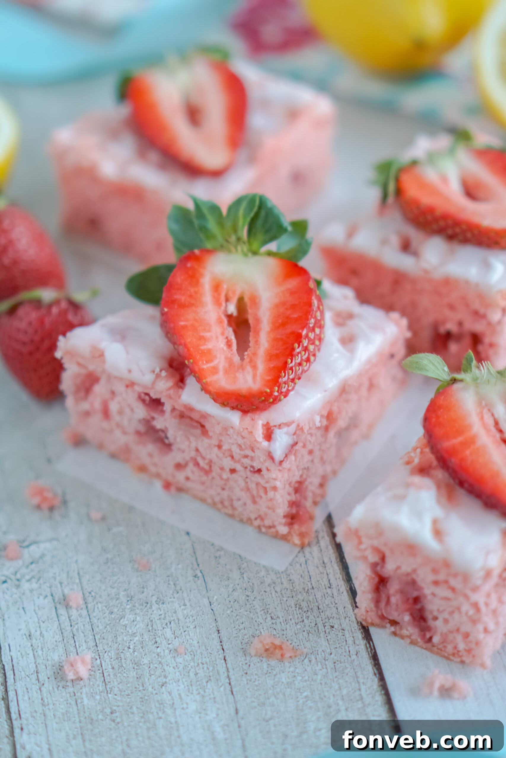 Front view of beautifully glazed Strawberry Lemon Brownies on parchment paper.