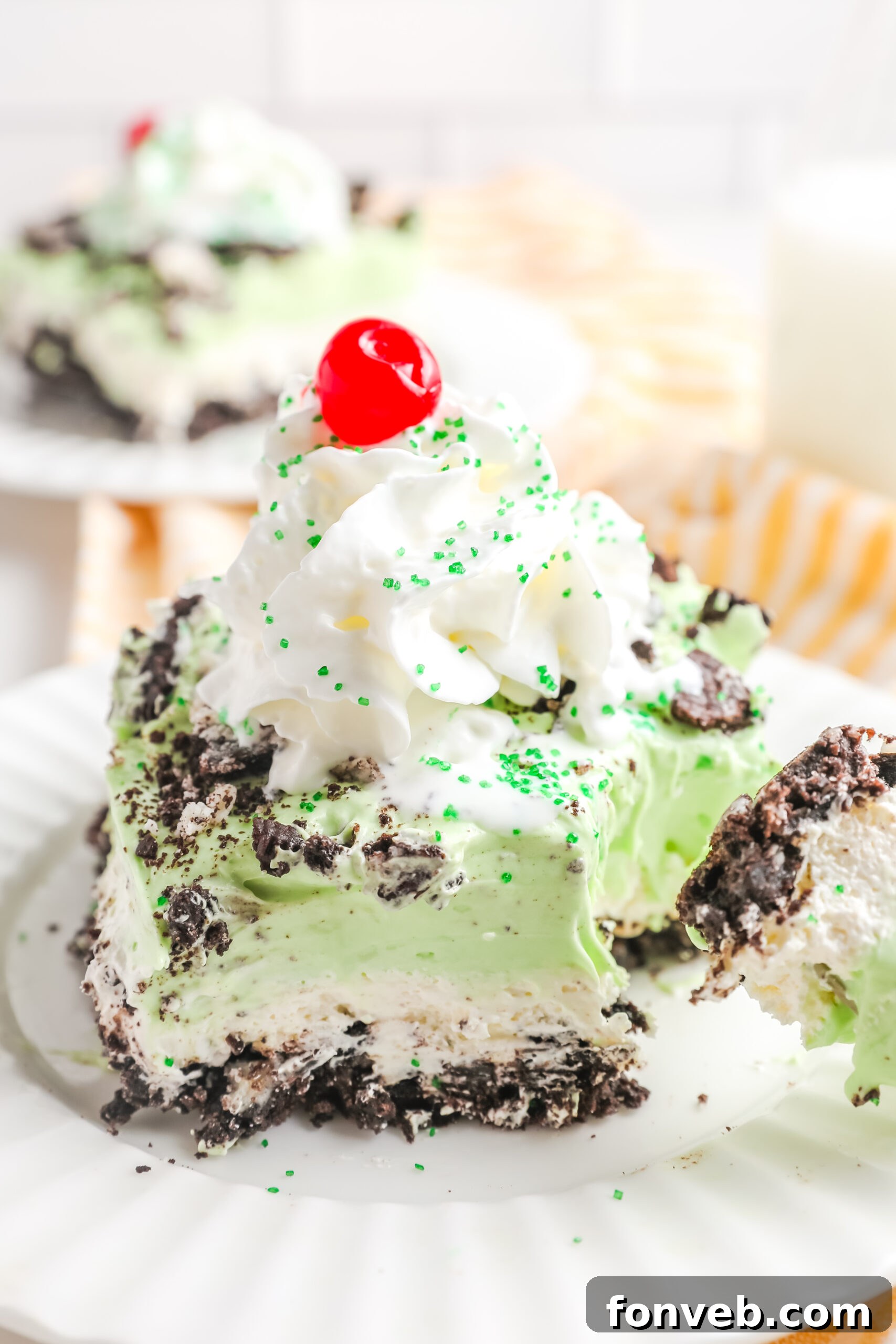 Emerald Lasagna 12 A very close-up detail shot of a fork removing a bite from a slice of Shamrock Lasagna, focusing on the distinct, moist layers.