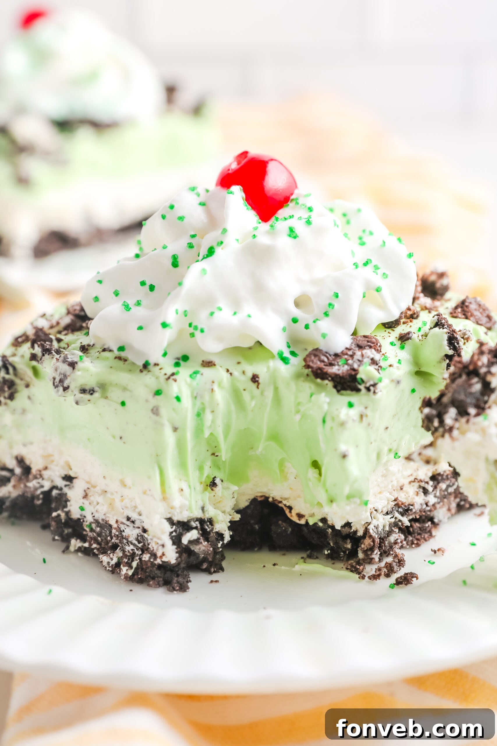 Emerald Lasagna 10 A close-up view of a bite removed from a slice of Shamrock Lasagna, highlighting the fluffy, creamy texture of the green layer.