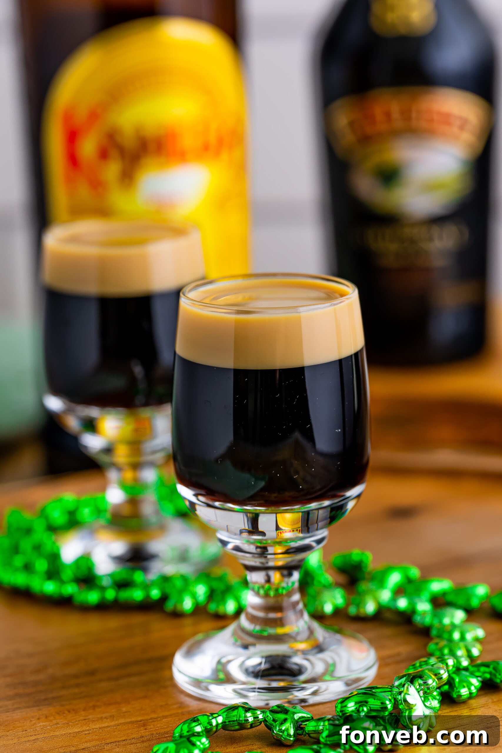 Mock Guinness Shots 2 Two Baby Guinness Shots on a wooden board with a green shamrock necklace.
