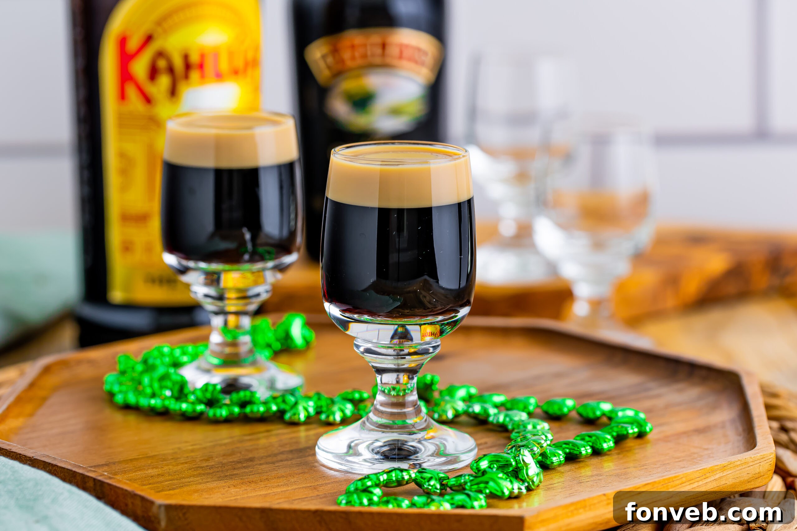 Mock Guinness Shots 12 Two Baby Guinness Shots on a wooden board with a green shamrock necklace.
