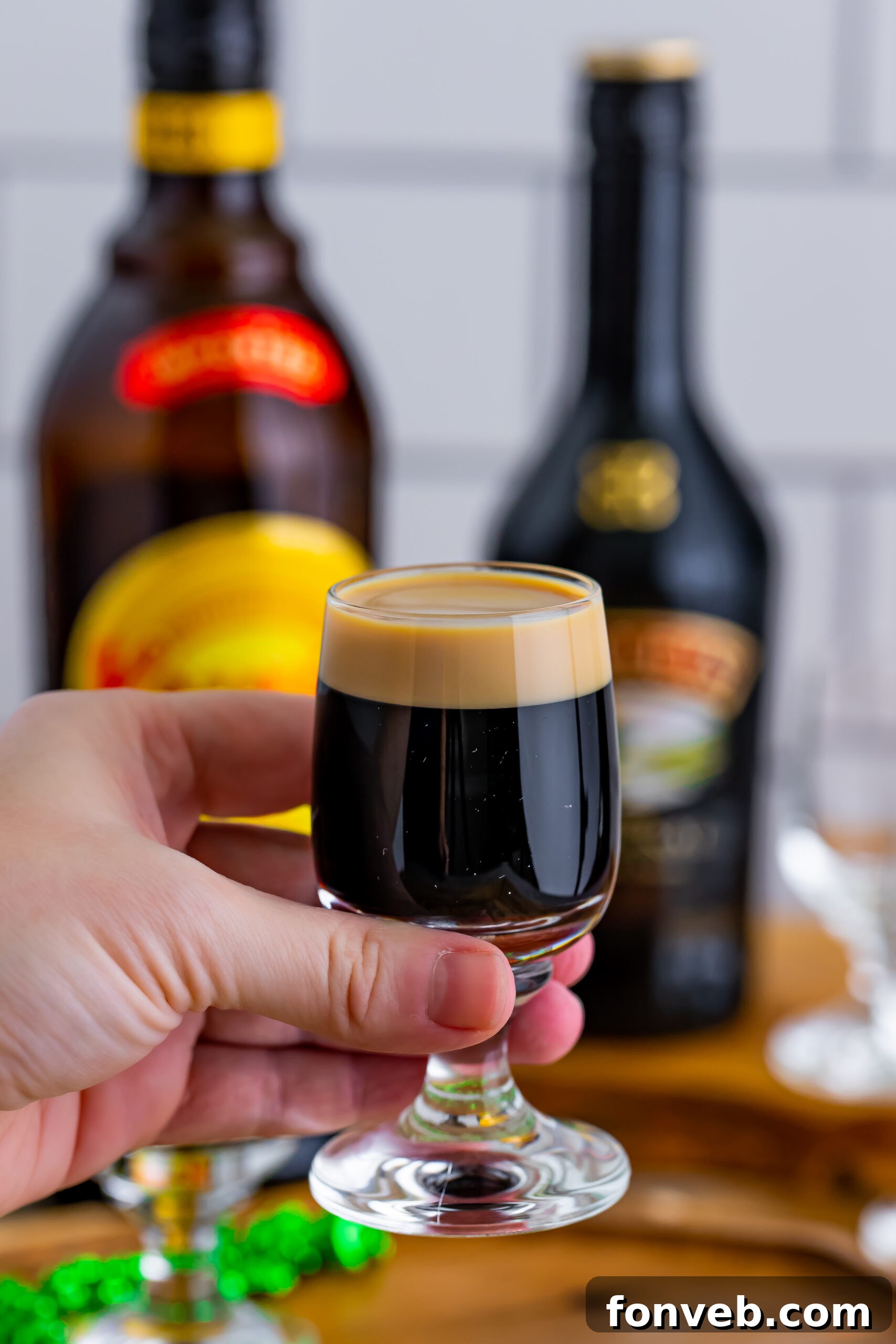 Mock Guinness Shots 4 A hand holding a baby Guinness Shot.