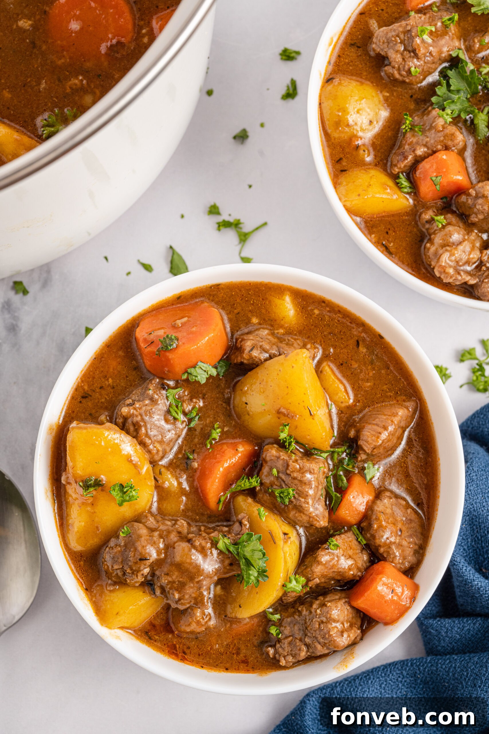 Irish Stew in a white bowl with a blue linen. 