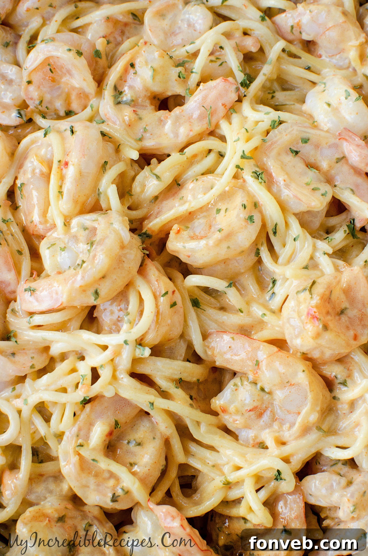 Close-up of shrimp and chicken being stir-fried in a pan.