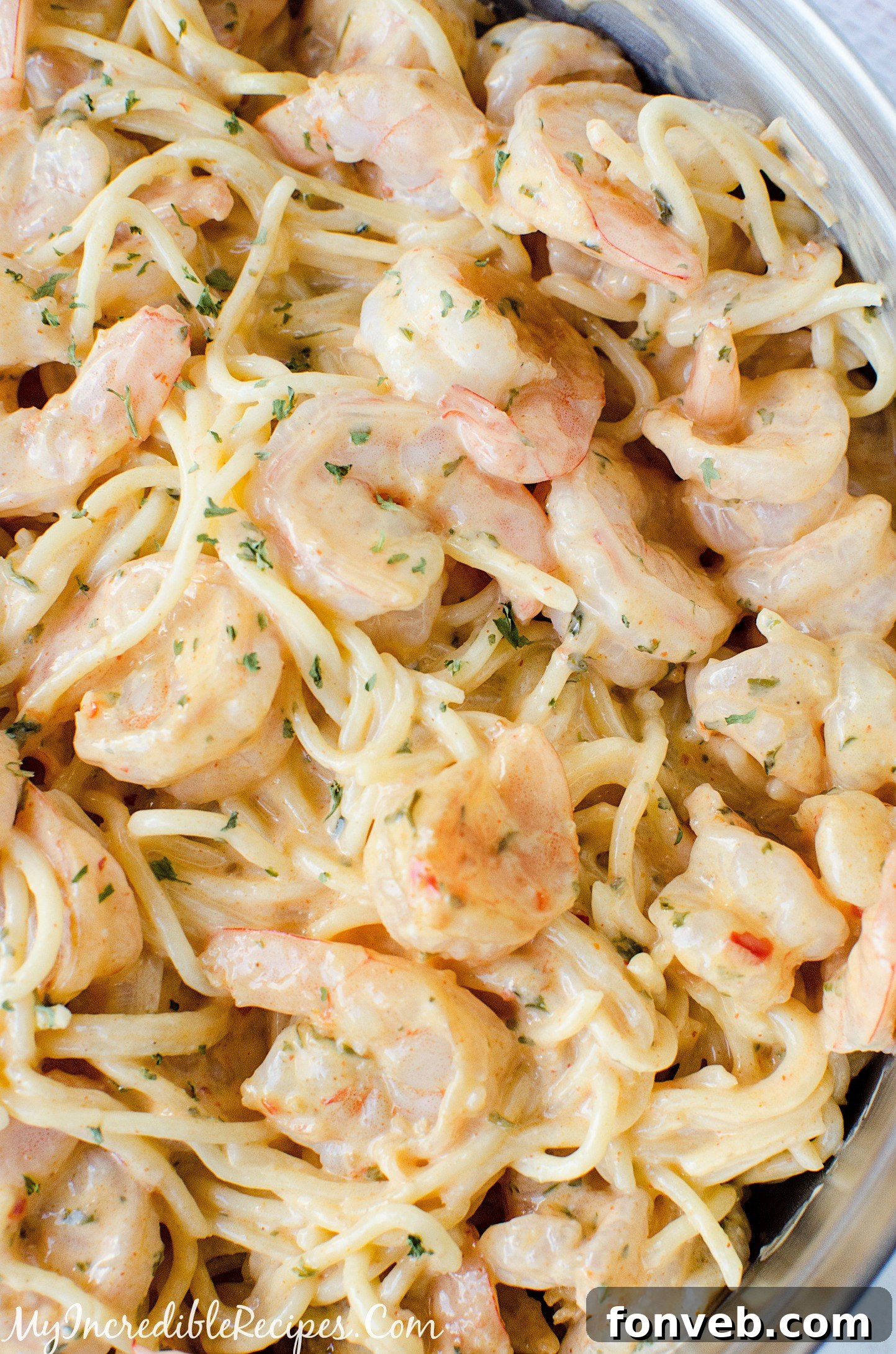 A bowl of Bang Bang Shrimp Pasta ready to be served, garnished with fresh herbs.