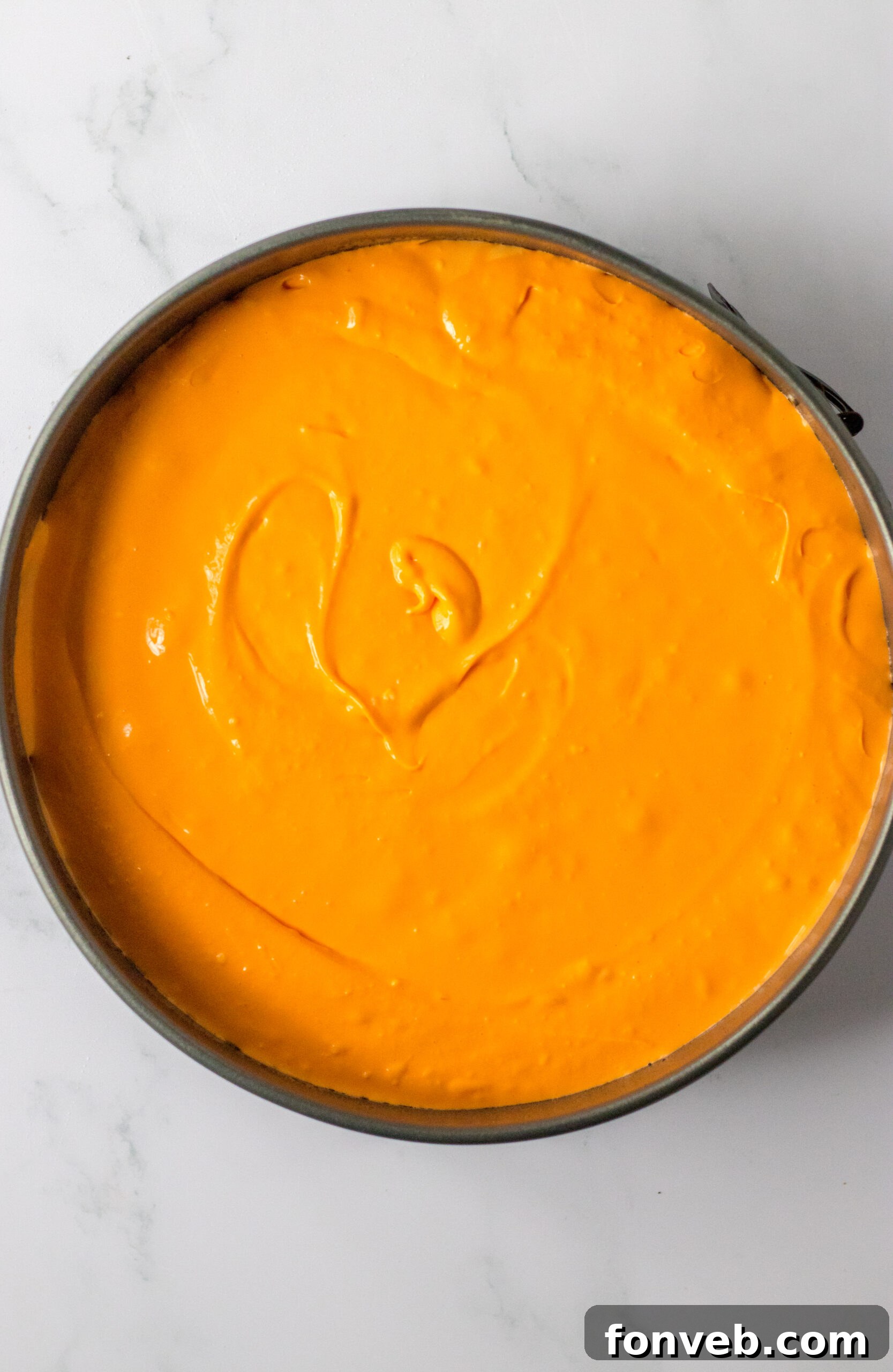 Softened cream cheese, sugar, and vanilla extract being combined in a mixing bowl.