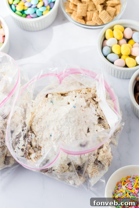 Close-up of the cereal and pretzels coated in white almond bark.