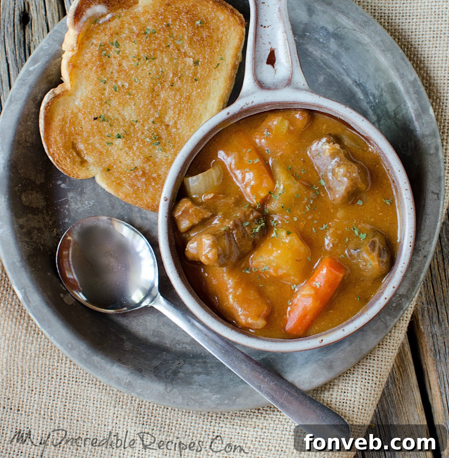 Close-up of Garlic Bread Dipped in Beef Stew