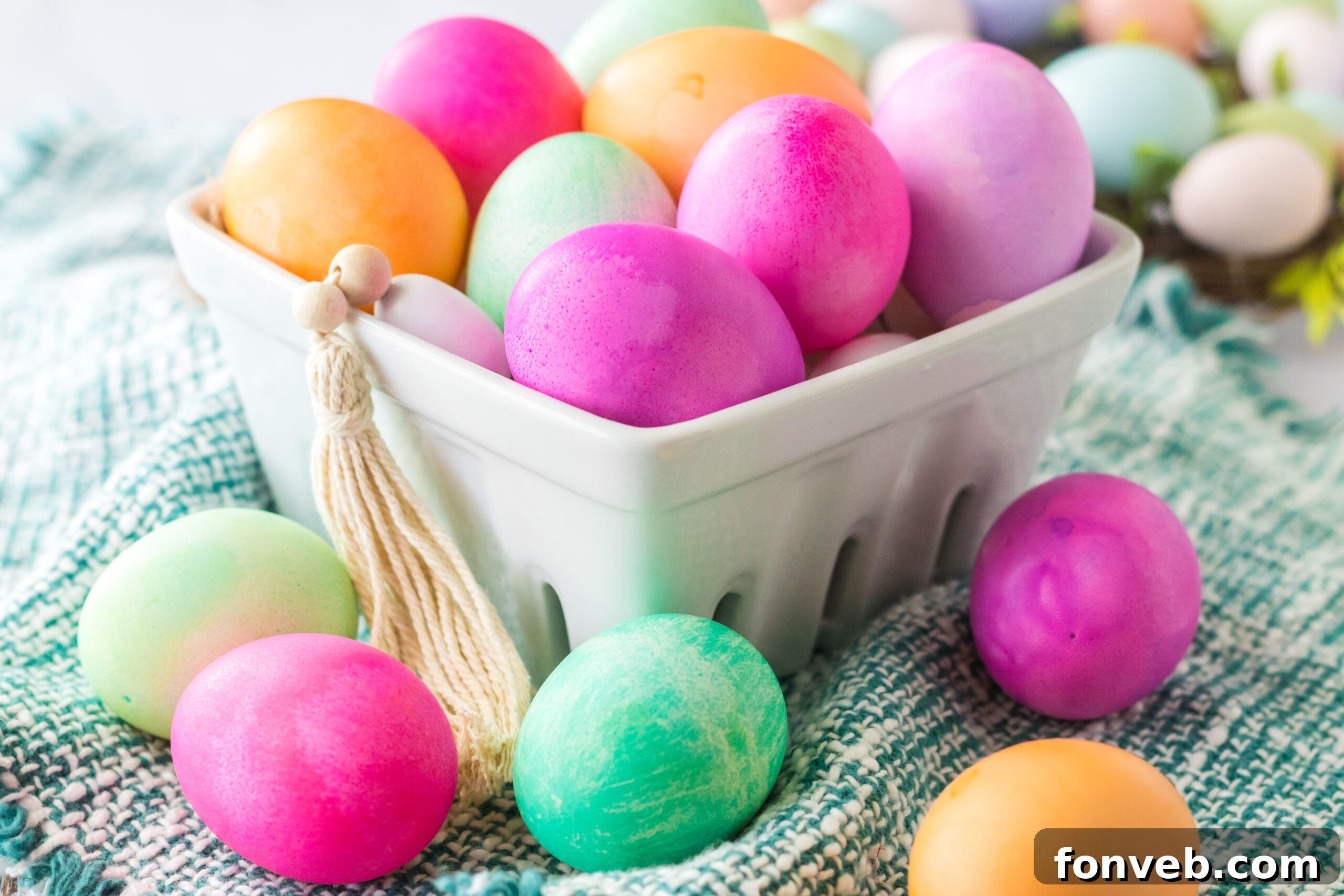 Dyed Easter Eggs in a white glass container. 