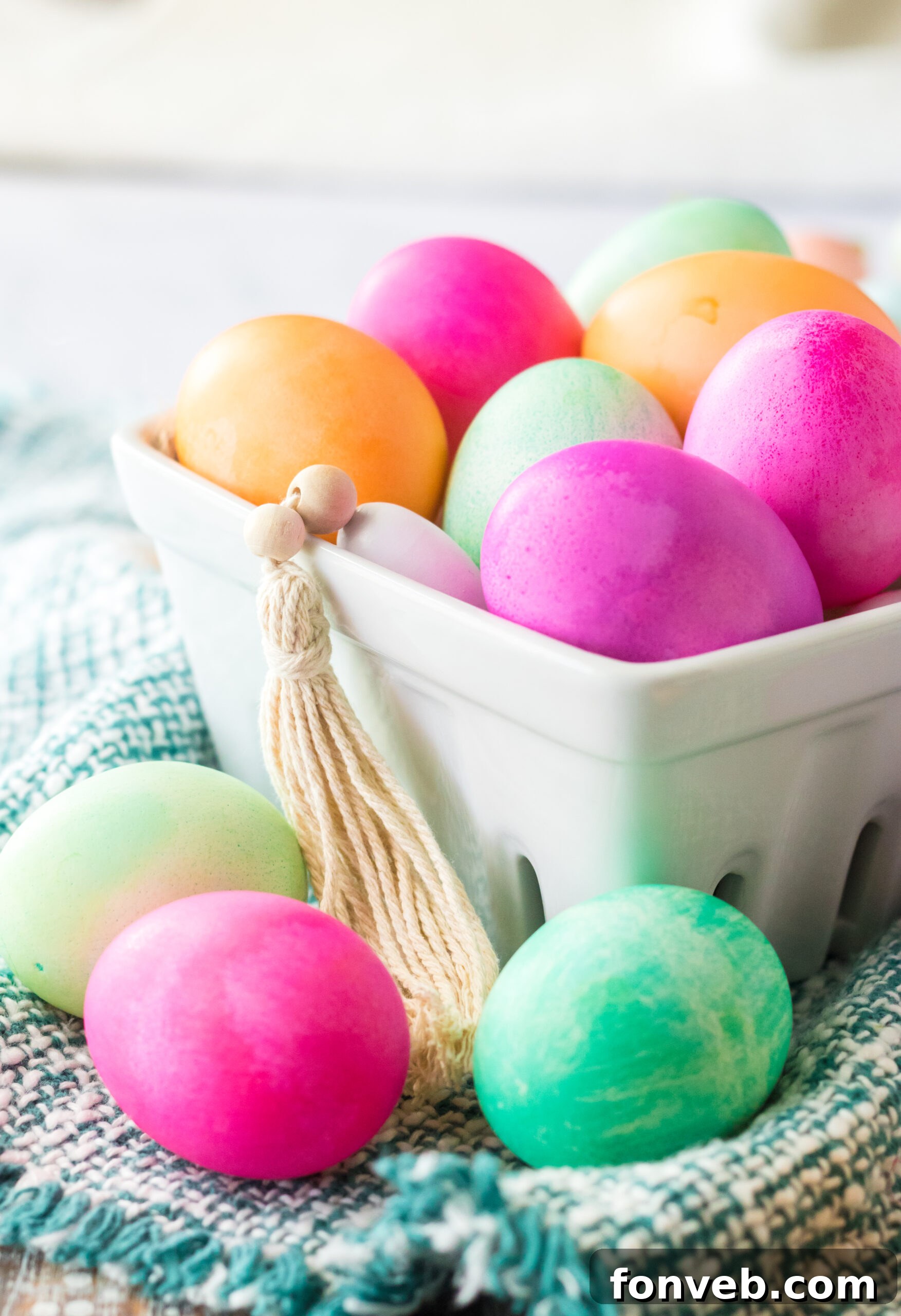 Close up shot of Dyed Easter Eggs in a white glass container. 