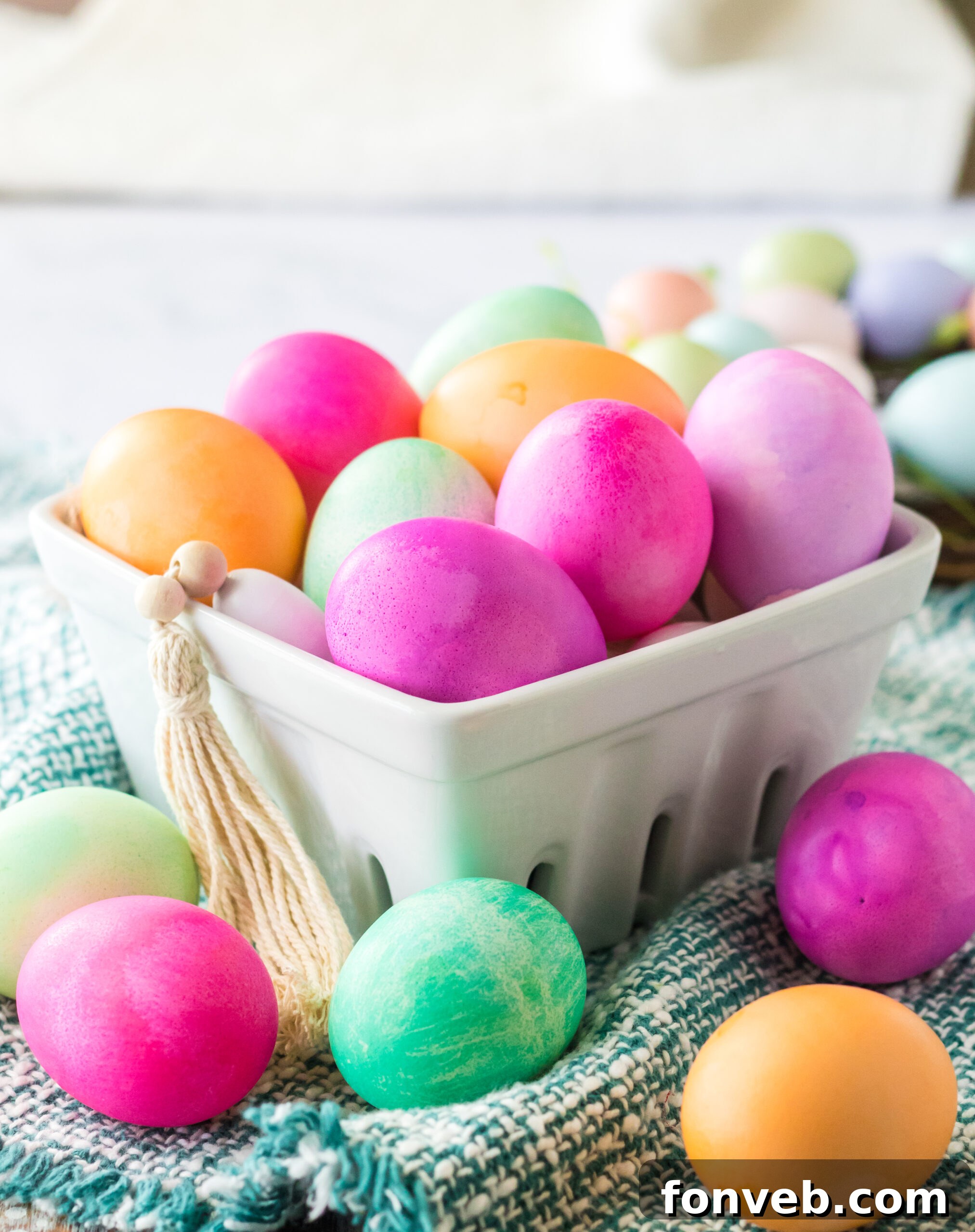 Dyed Easter Eggs in a white glass container. 