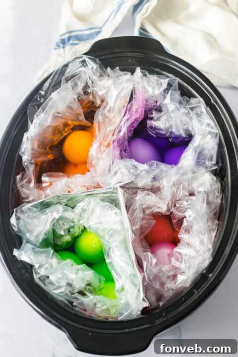 Several slow cooker dyed Easter eggs in a white bowl.