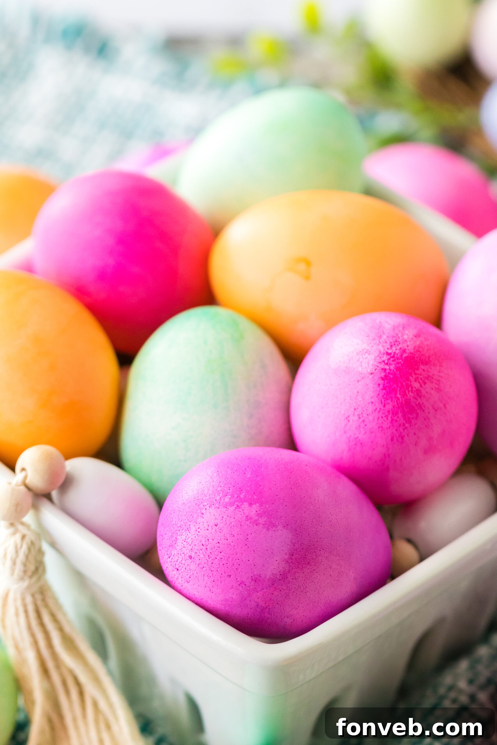 Close up shot of Dyed Easter Eggs in a white glass container. 