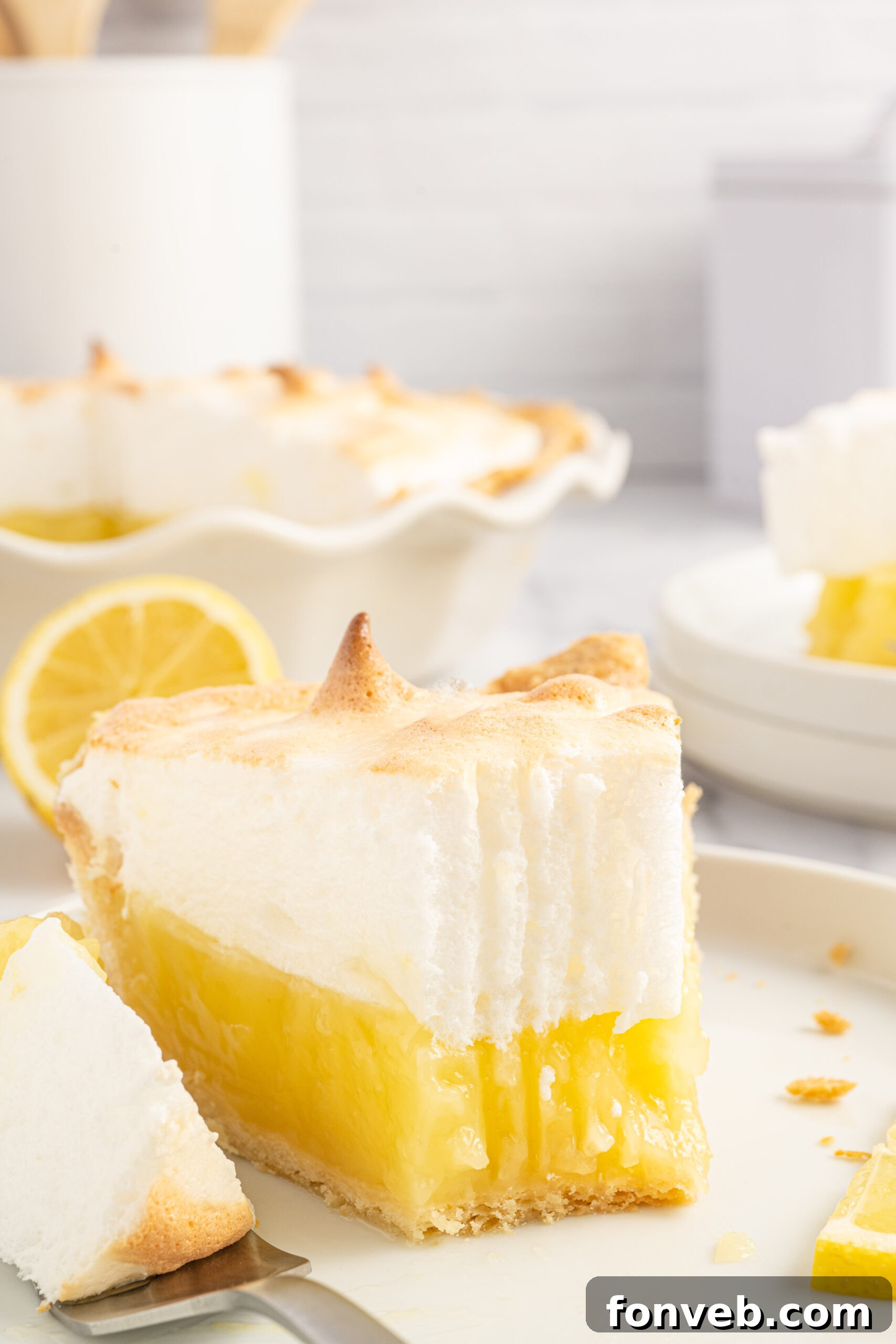 A close up bite shot of the fresh lemon meringue pie. 