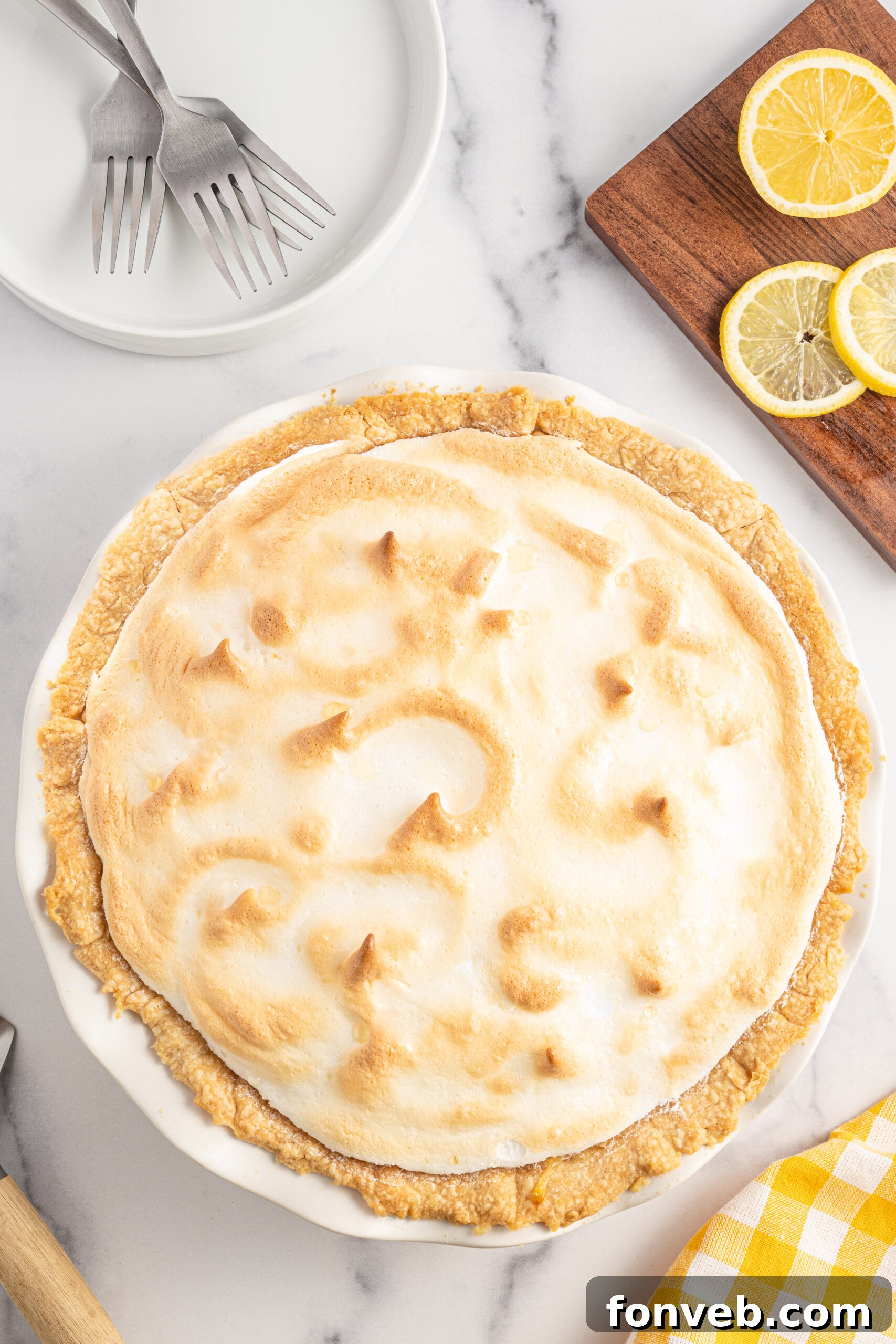 Overhead shot of lemon meringue pie in a white pie dish. 