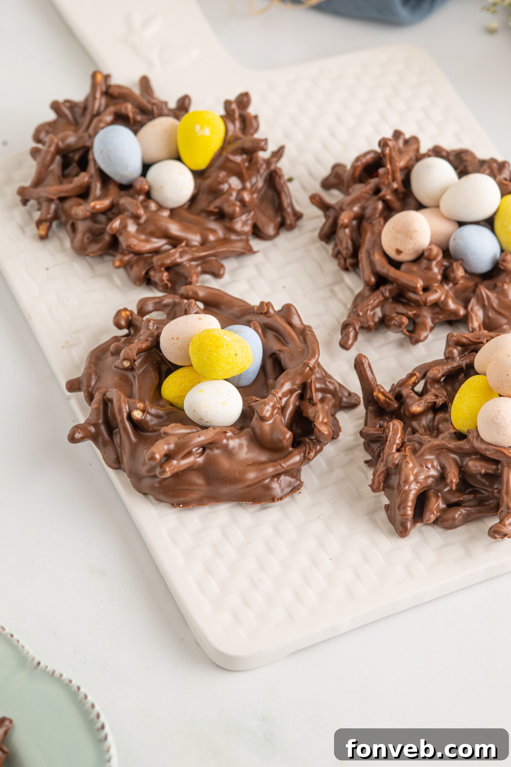 Whimsical Bird Nests 13 Birds Nest Cookies on a white serving tray.