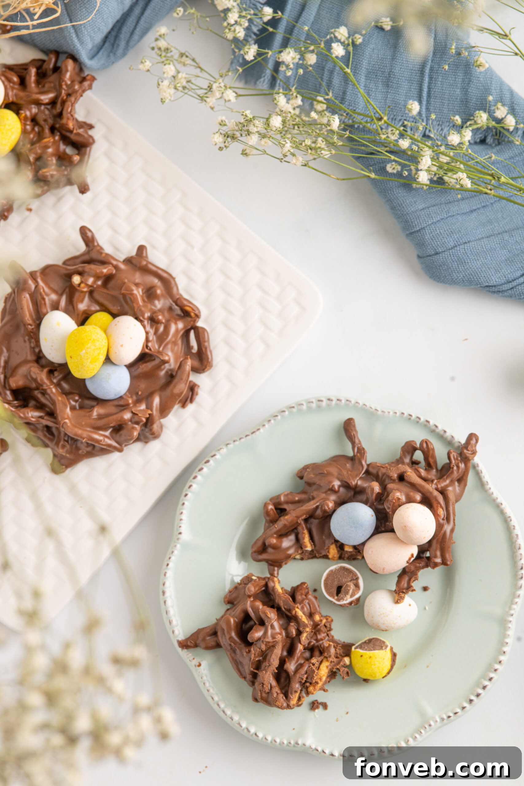 Whimsical Bird Nests 15 Overhead shot of a cookie cut in half on a teal plate.