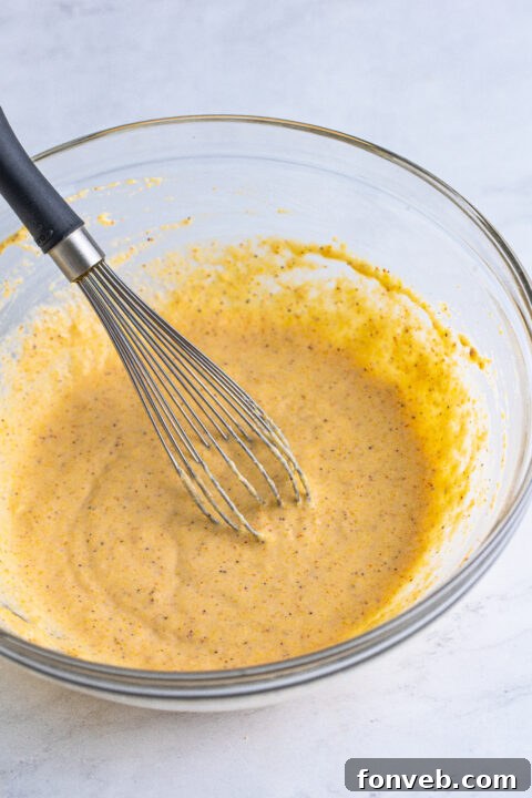 Close-up of a bowl containing dry batter ingredients.