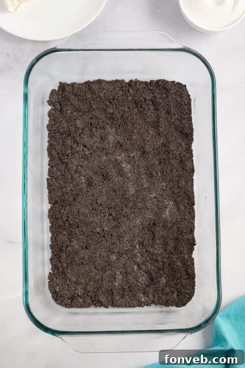 Reese's Peanut Butter Cup Lasagna 7 Crushed Oreos mixed with melted butter, ready to form the crust of the Reese's lasagna.