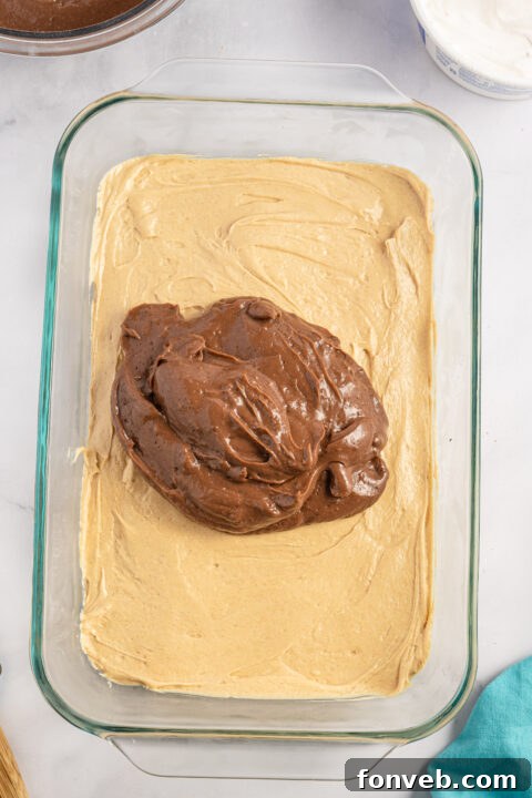 Reese's Peanut Butter Cup Lasagna 8 The peanut butter and cream cheese mixture being smoothly blended in a mixing bowl.