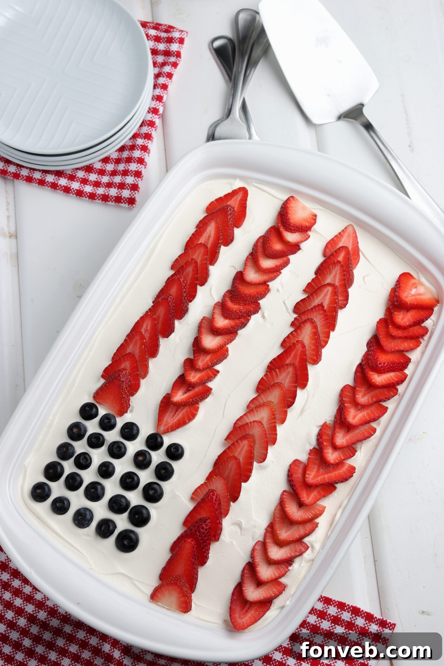 A beautifully decorated American Flag Poke Cake in a white baking dish, ready to be served.