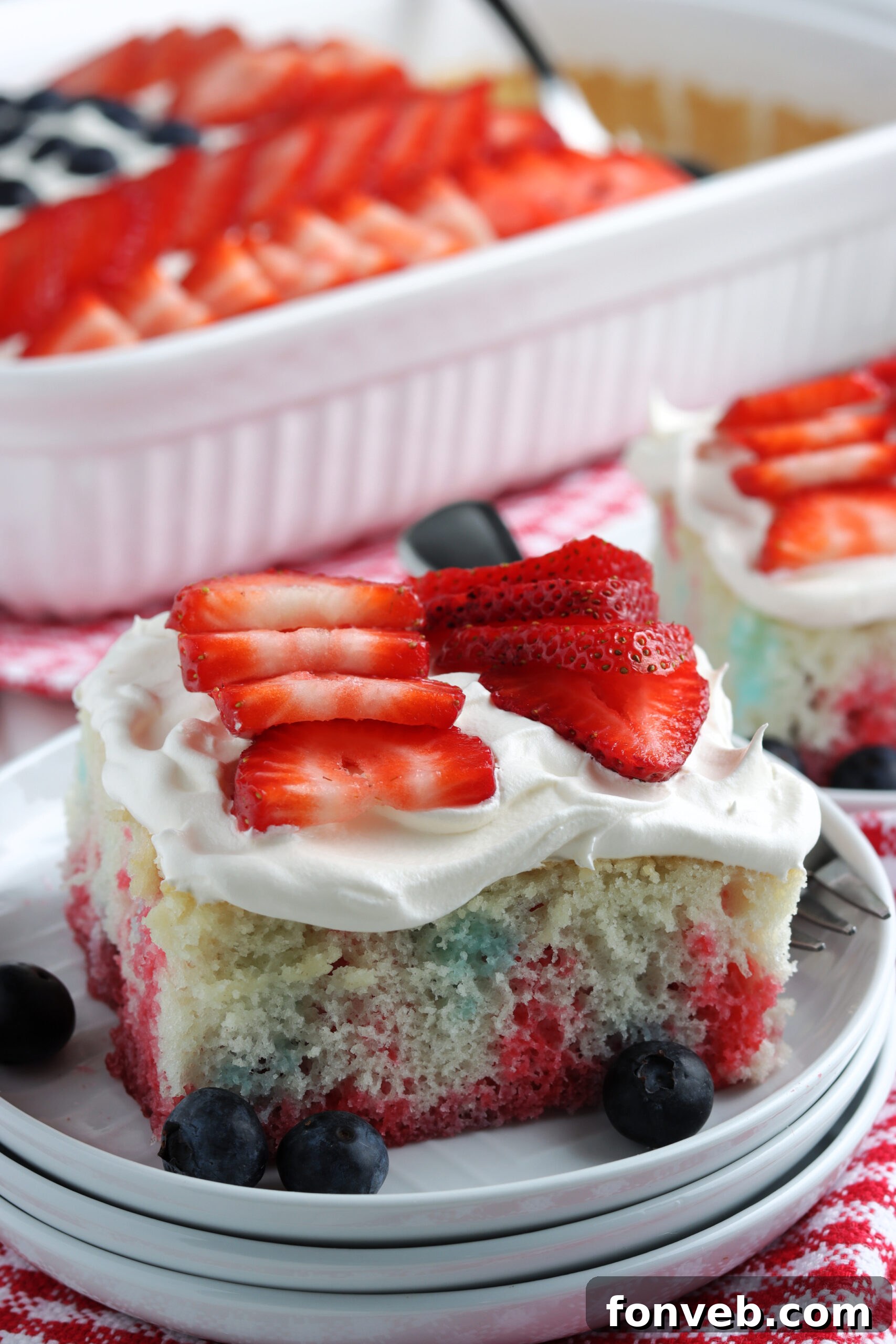 A top-down view of two slices of American Flag Cake on plates.