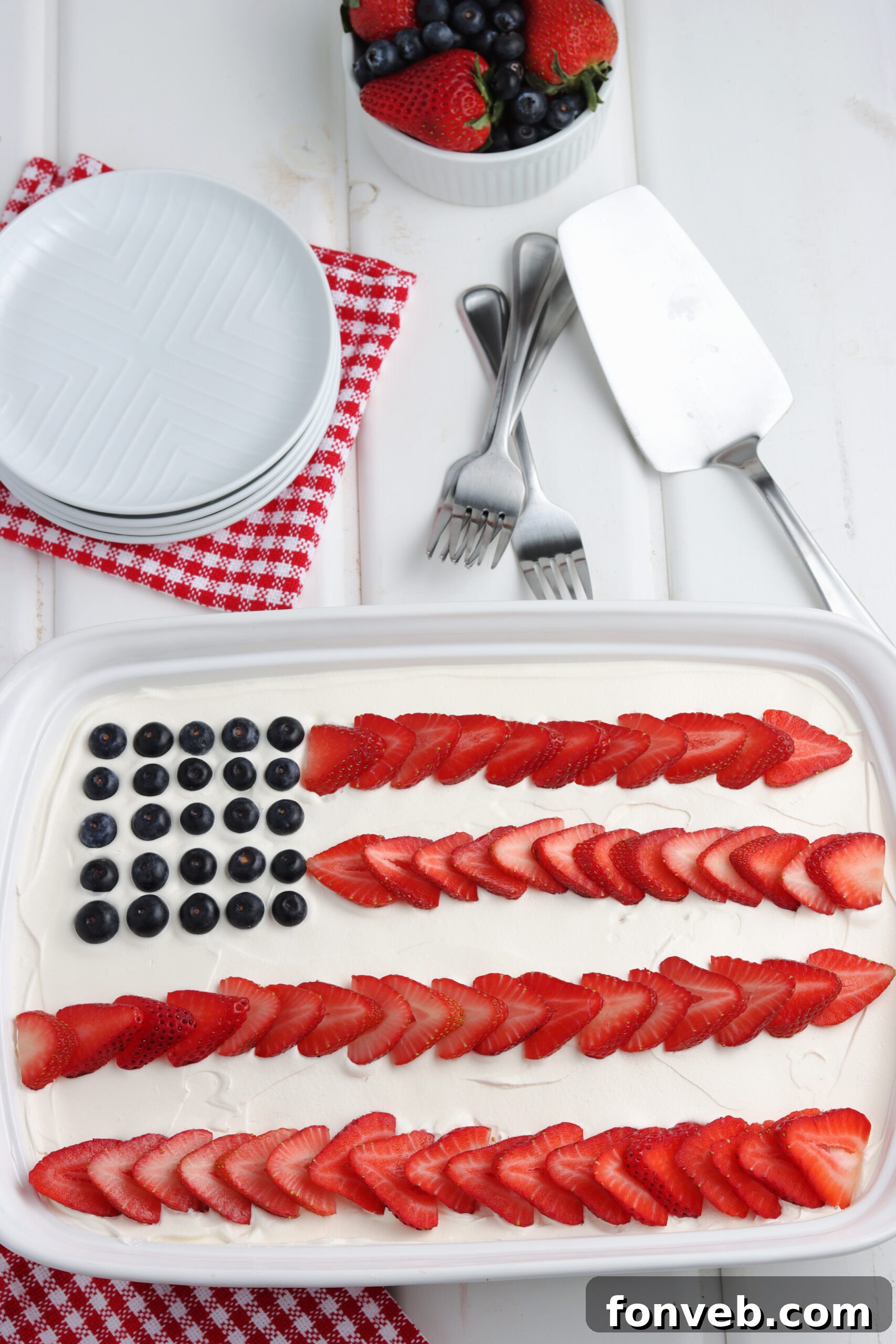 Close-up of the American Flag Poke Cake showing the vibrant red and blue gelatin streaks within the white cake.
