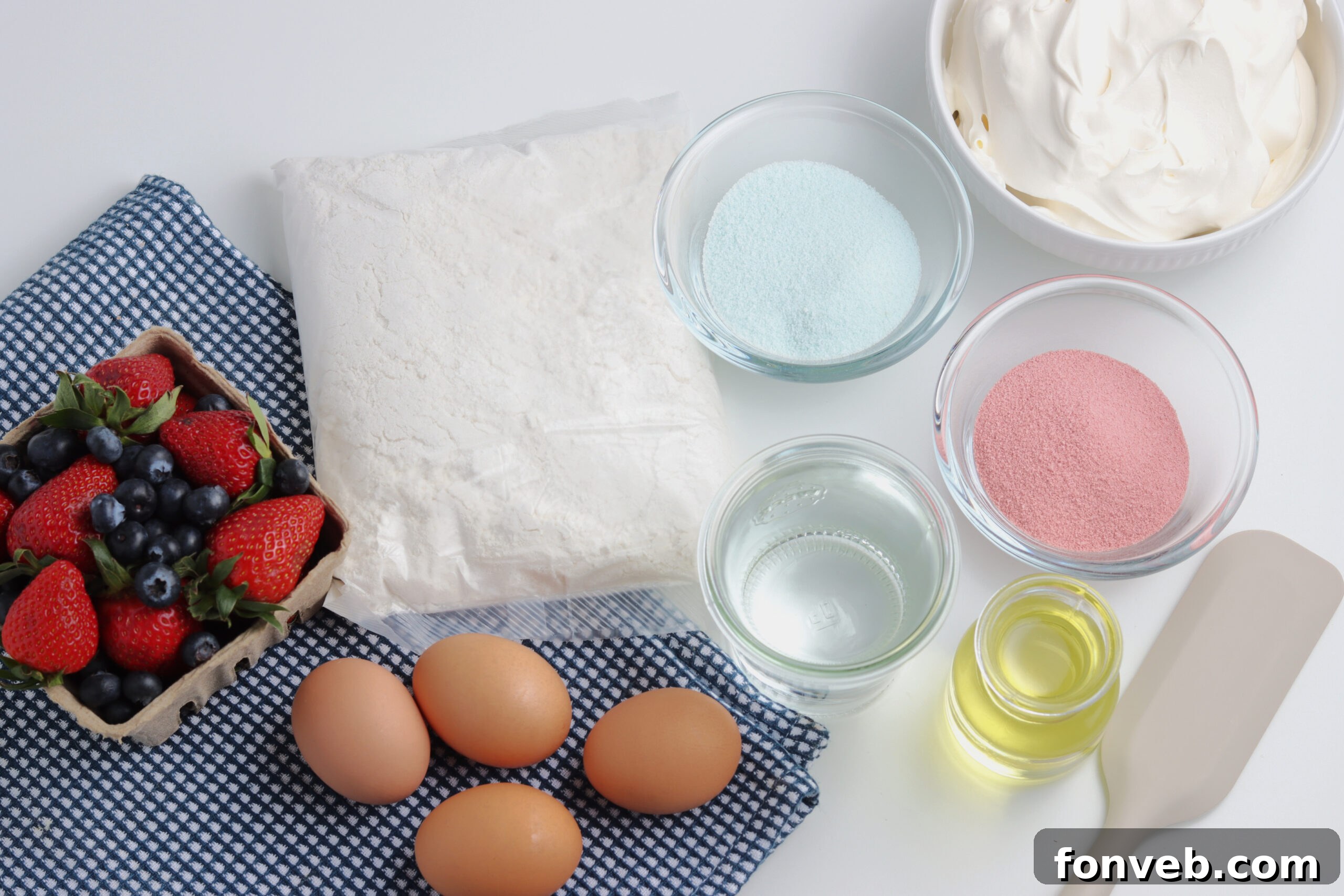 All the necessary ingredients for making the American Flag Cake laid out on a kitchen counter.