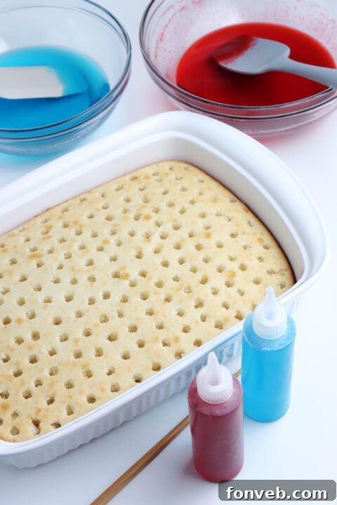 Blue gelatin being poured into the remaining holes of the cake.