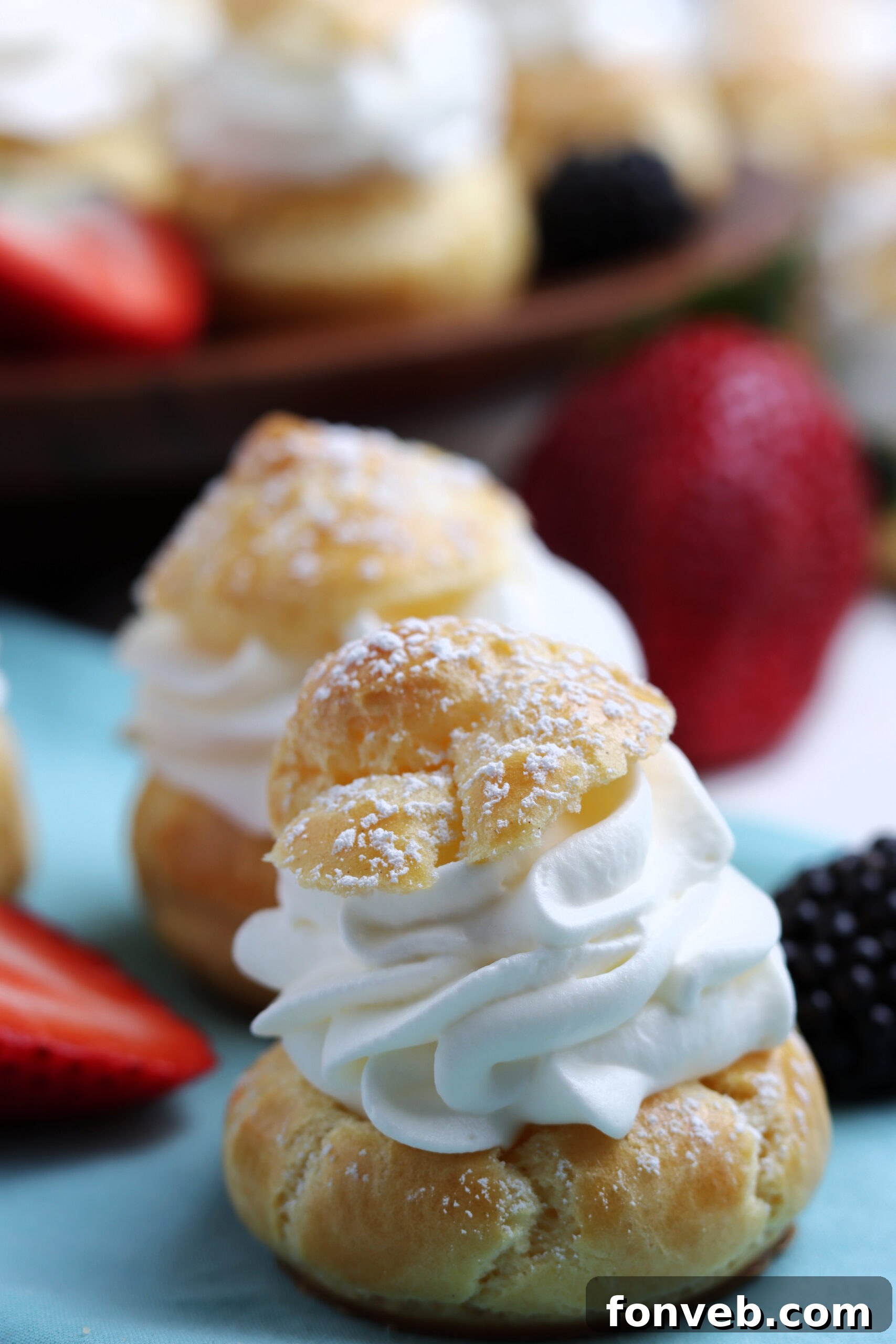 Close-up shot of a cream puff generously sprinkled with powdered sugar, highlighting its texture.