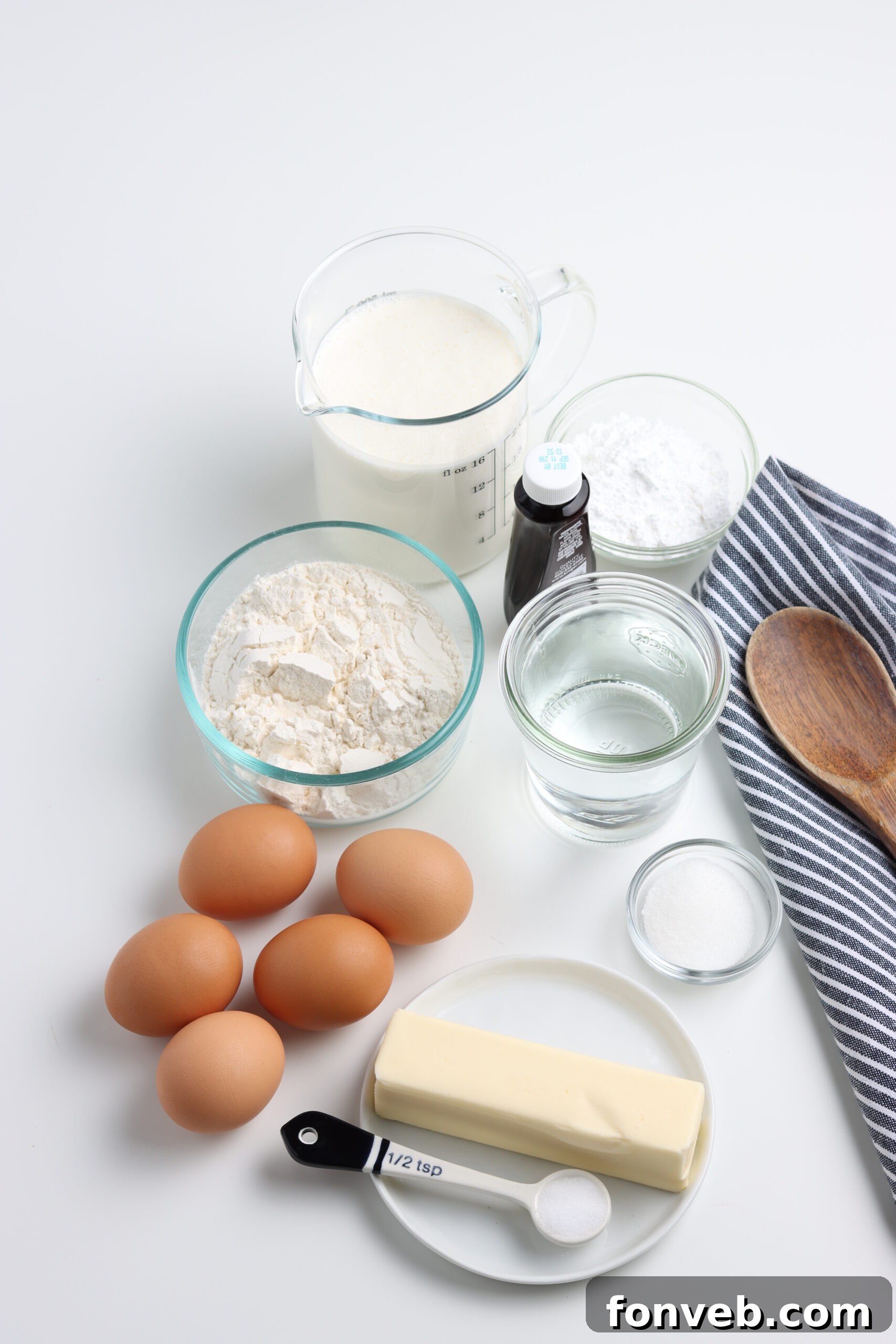 A selection of all the fresh ingredients laid out on a surface, ready to be used for making cream puffs.
