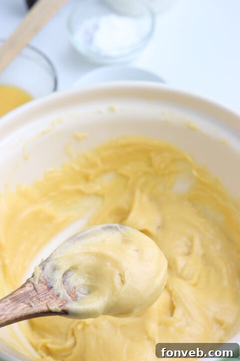 A bowl of rich, yellow pastry cream, showcasing its smooth and thick texture.