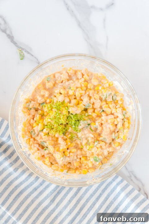 A close-up of the finely diced jalapeño being added to the salad mix, contributing a zesty kick.