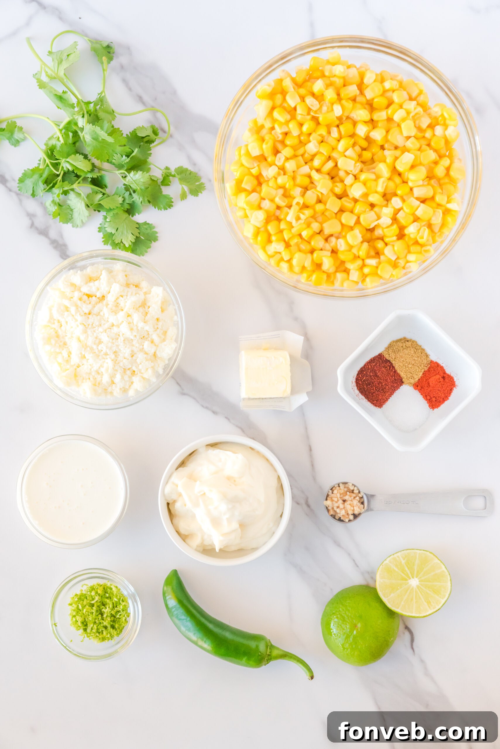 A flat lay photograph displaying all the fresh ingredients meticulously laid out, necessary for preparing this Mexican Street Corn Salad recipe.